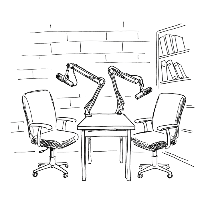 Two podcast armchairs facing each other across a low table with two boom microphones on jointed arms; brick wall and bookshelf hinted behind.